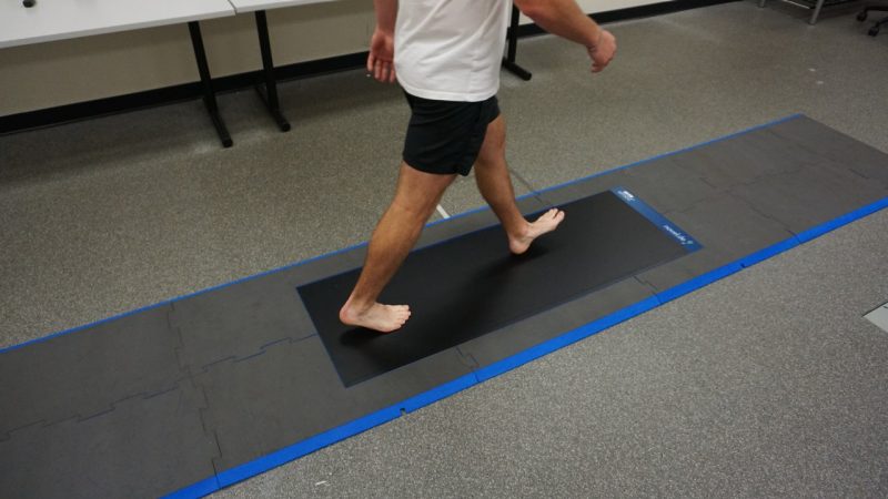 Image of a man walking barefoot on an emed xl pressure plate.