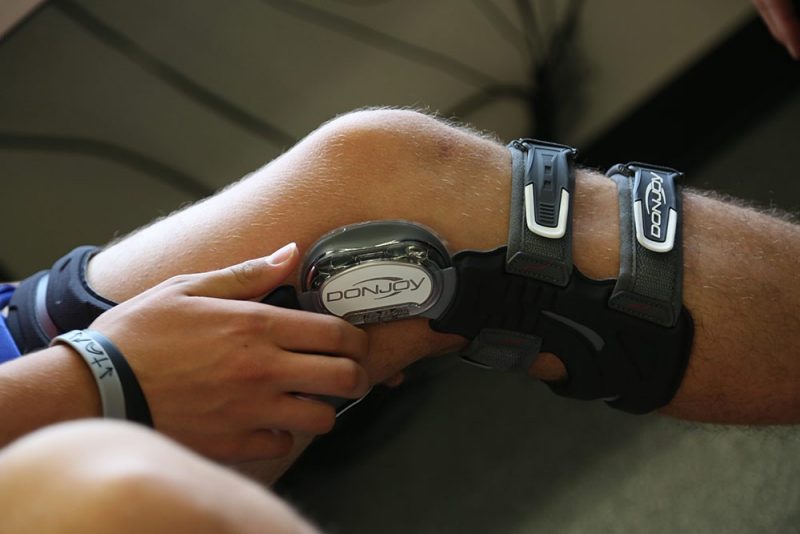A knee that is slightly bent with a brace on it