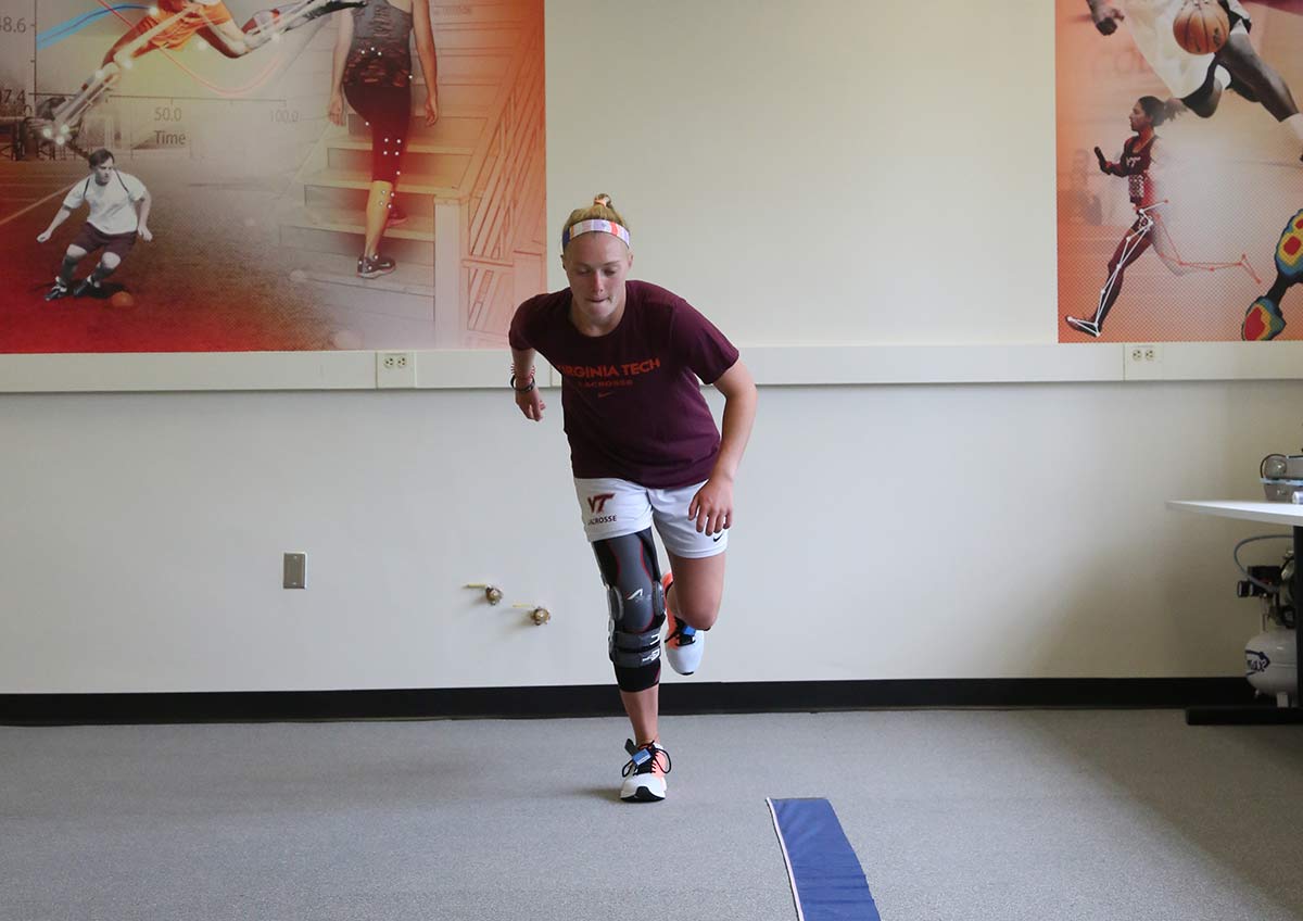 Image of a girl with a knee brace jumping on one leg in the Granata Biomechanics Lab