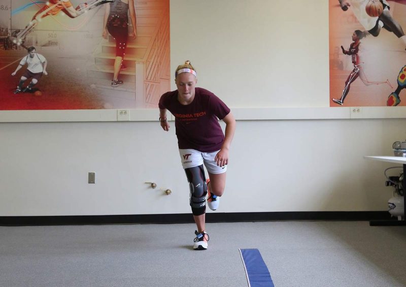 Image of a girl with a knee brace jumping on one leg in the Granata Biomechanics Lab