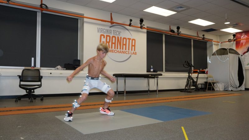 Image of a boy shuffling side to side on force plates.